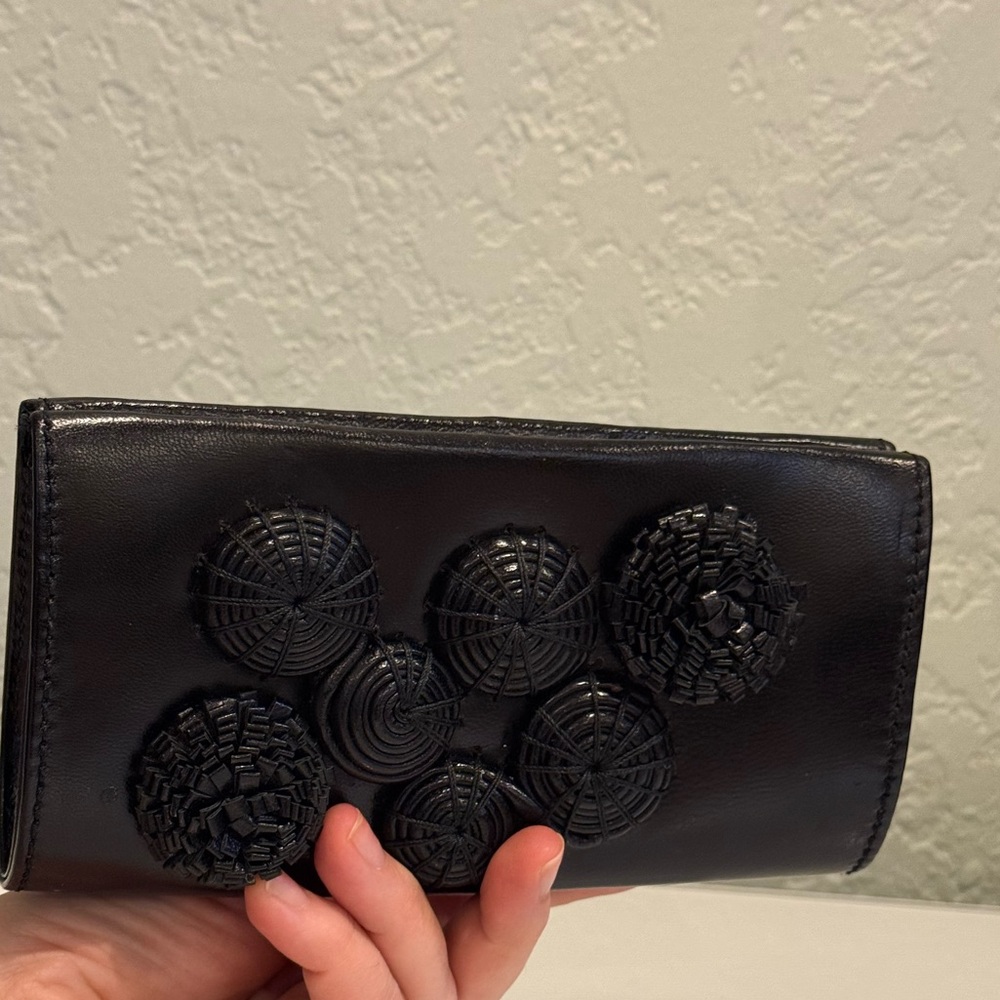 Sarah Chofakian
Black leather Clutch with flower Design in excellent condition